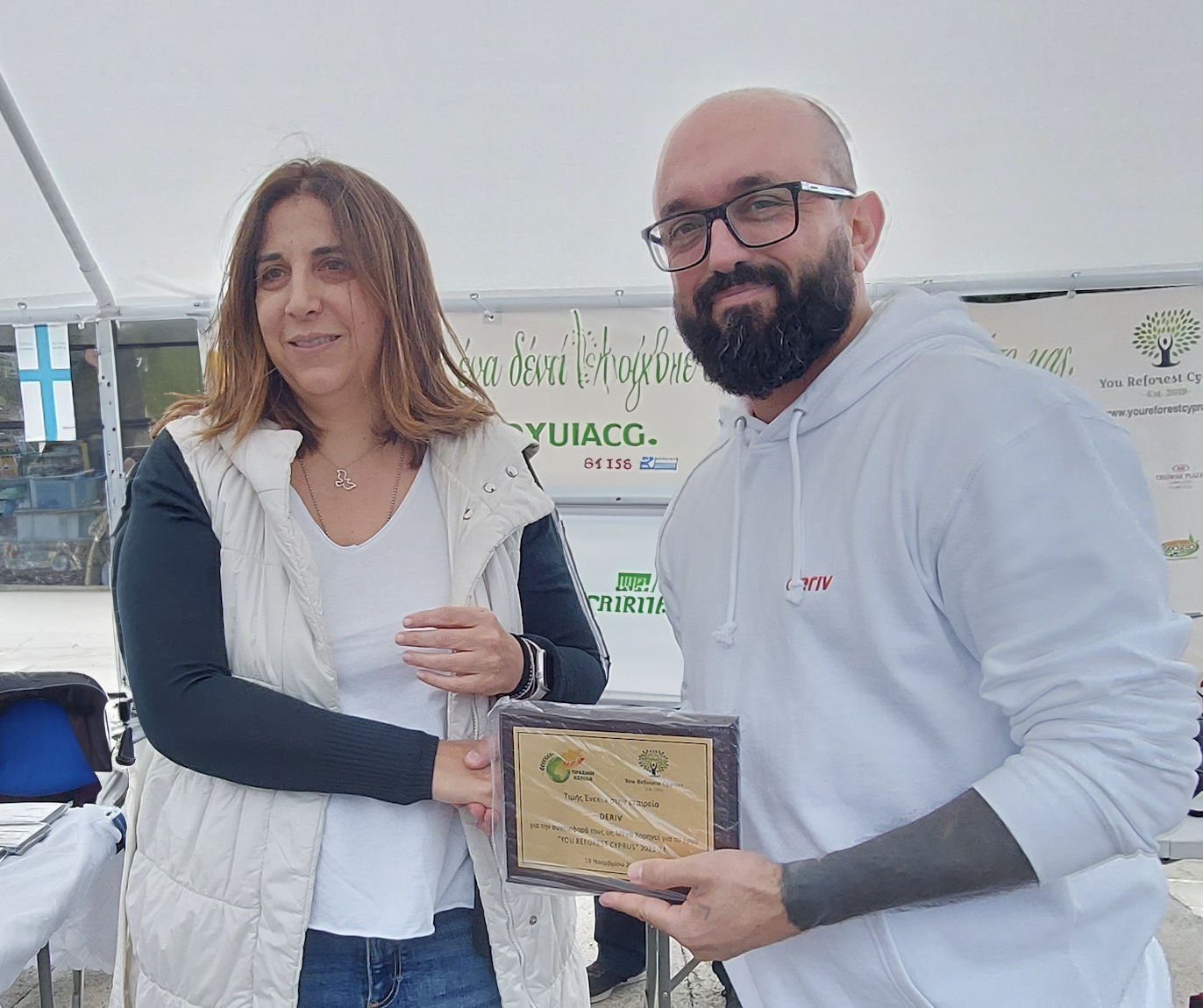 Geo Nicolaidis, Head of Deriv Cyprus, receives Green Shields plaque of appreciation.