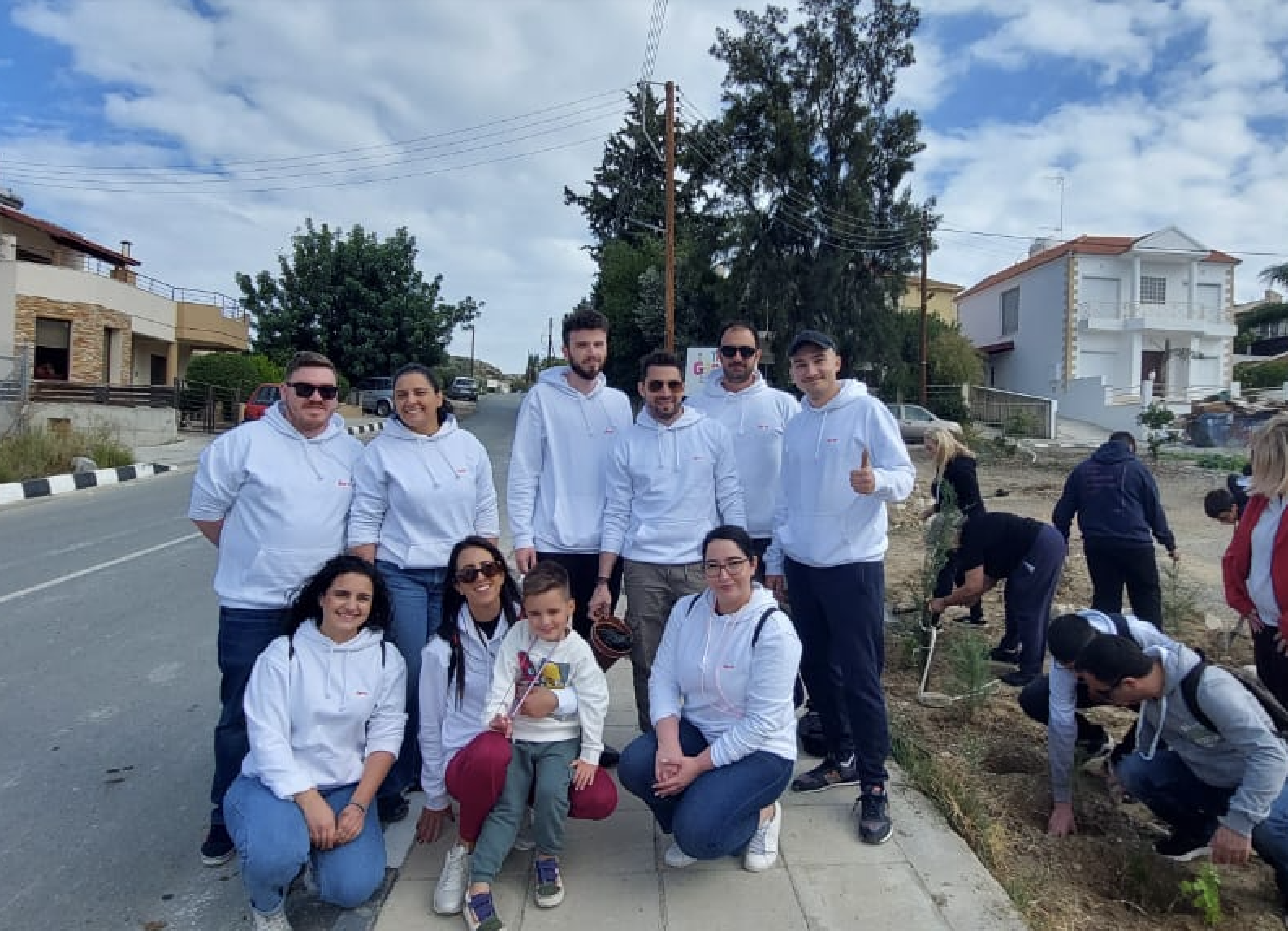 Deriv Cyprus team and their families after planting the 2,000 saplings donated by Deriv.