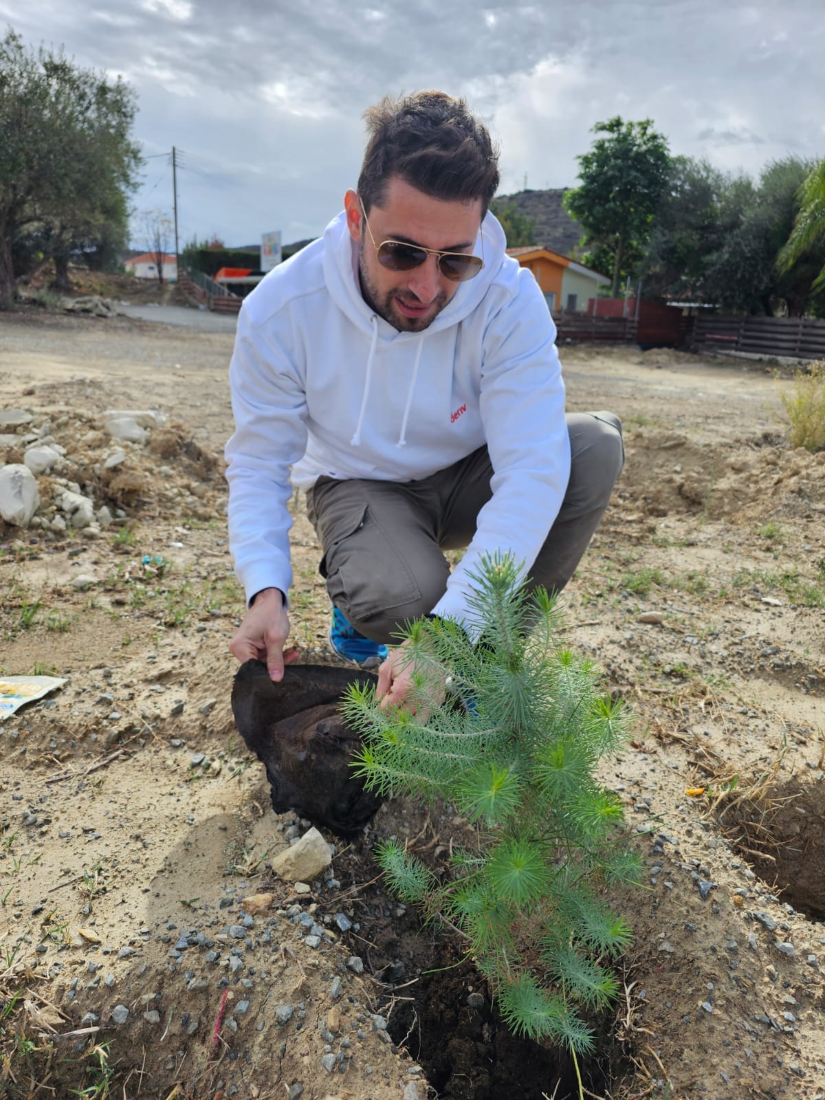Deriv Cyprus employee planting a tree