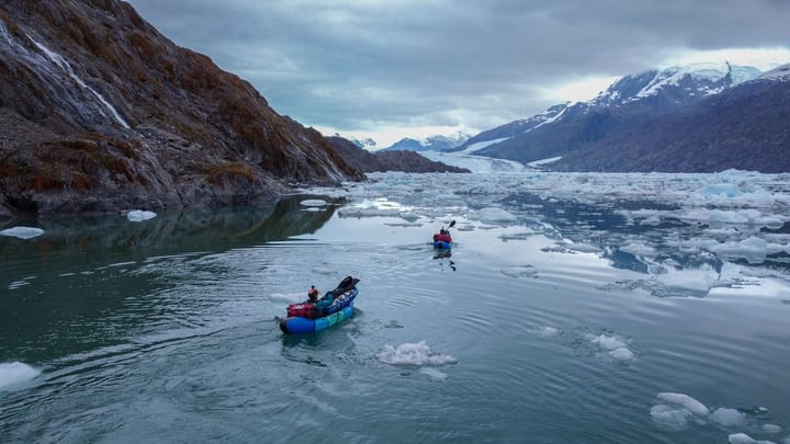 Two Kahuna team members rowing across an icy lake.